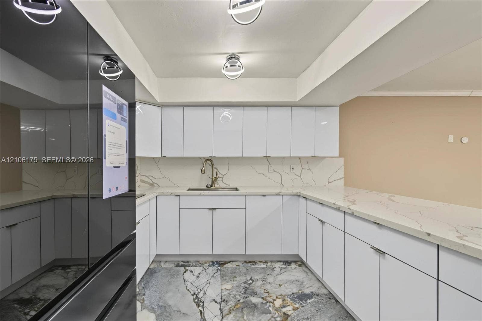 6905 W 2nd Way, #1, Hialeah, Hialeah, FL 33014 Kitchen featuring white flat-panel cabinetry, light stone-patterned countertops, a matching full-height backsplash, polished stone flooring, and modern circular flush-mount lighting fixtures