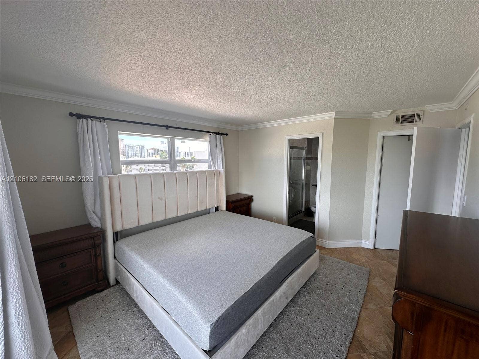 400 Golden Isles Drive, #40, Hallandale Beach, Hallandale Beach, FL 33009 Neutral-toned room featuring stone-finish flooring and crown molding