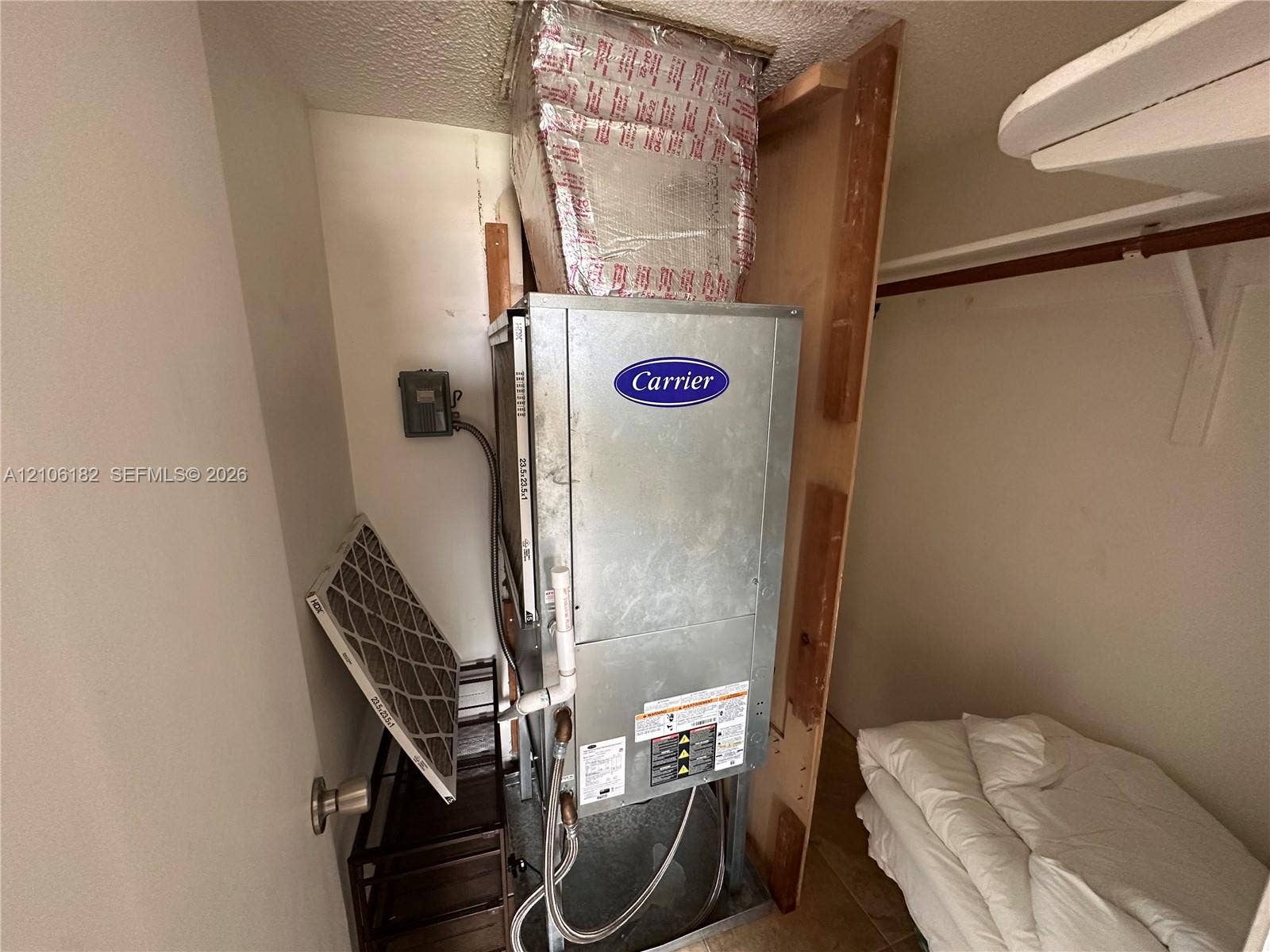 400 Golden Isles Drive, #40, Hallandale Beach, Hallandale Beach, FL 33009 Carrier HVAC unit featuring a metal air handler, insulated ductwork, and integrated filtration system