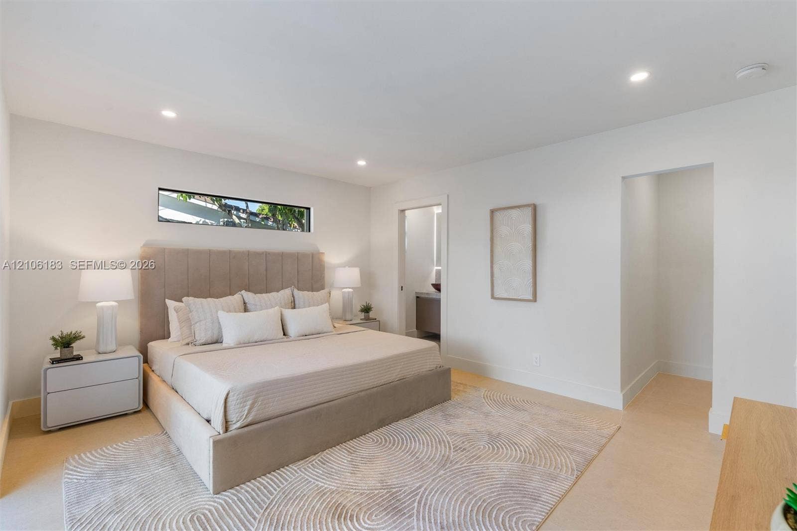 Neutral interior featuring recessed lighting, smooth-finish walls, wood-finish flooring, and a horizontal clerestory window