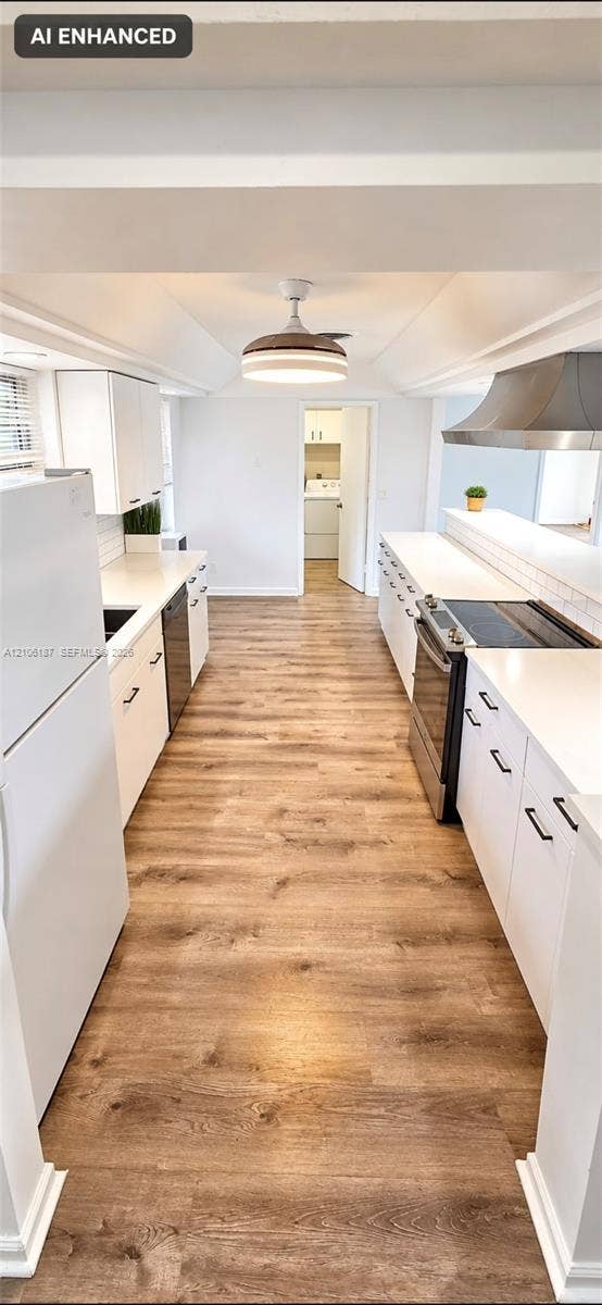 Kitchen featuring white cabinetry, solid-surface countertops, wood-finish flooring, a stainless steel range hood, and a ceiling-mounted light fixture