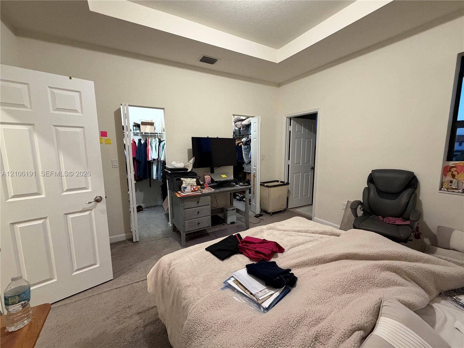 3402 W 105th Street, Hialeah, FL 33018 Tray ceiling featuring a recessed center, neutral wall paint, and carpeting