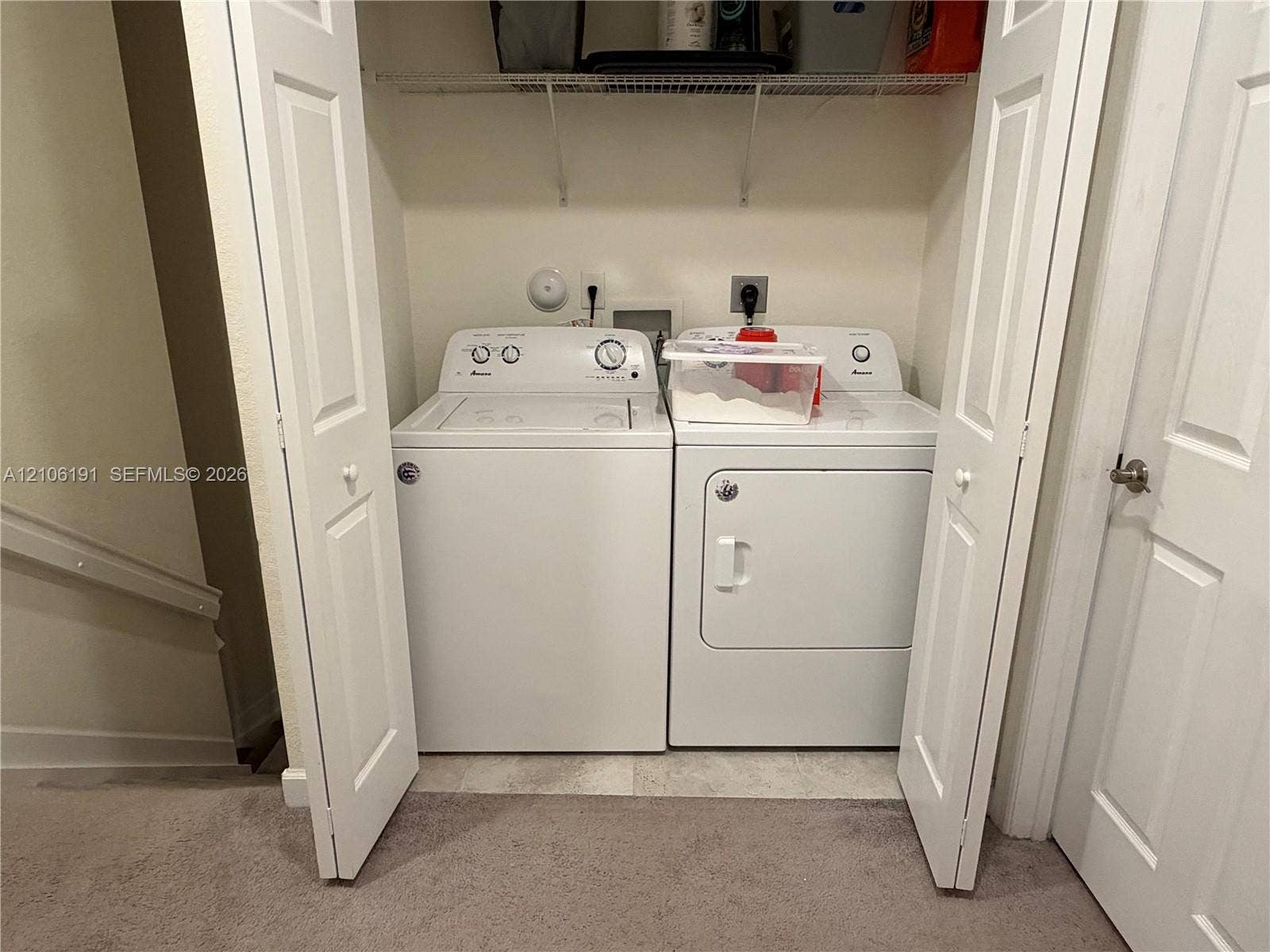 3402 W 105th Street, Hialeah, FL 33018 Laundry closet featuring bifold doors and built-in wire shelving