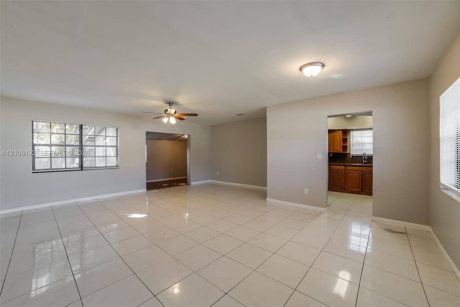 19100 NW 12th Avenue, Miami Gardens, Miami Gardens, FL 33169 Spacious interior featuring large-format tile flooring, recessed and ceiling-mounted lighting, a multi-blade ceiling fan, and windows with integrated blinds
