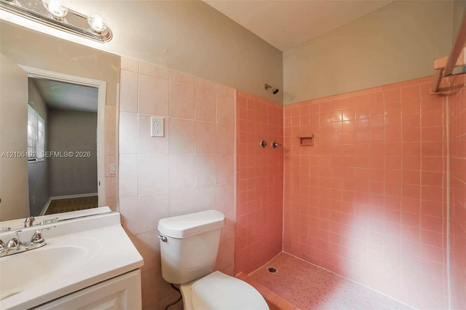 19100 NW 12th Avenue, Miami Gardens, Miami Gardens, FL 33169 Bathroom featuring ceramic wall tiling, white vanity with integrated sink, chrome-finished hardware, and walk-in shower enclosure