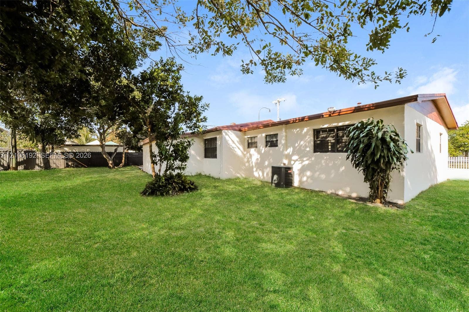 19100 NW 12th Avenue, Miami Gardens, Miami Gardens, FL 33169 Expansive backyard featuring a level lawn, mature trees, and a fenced perimeter