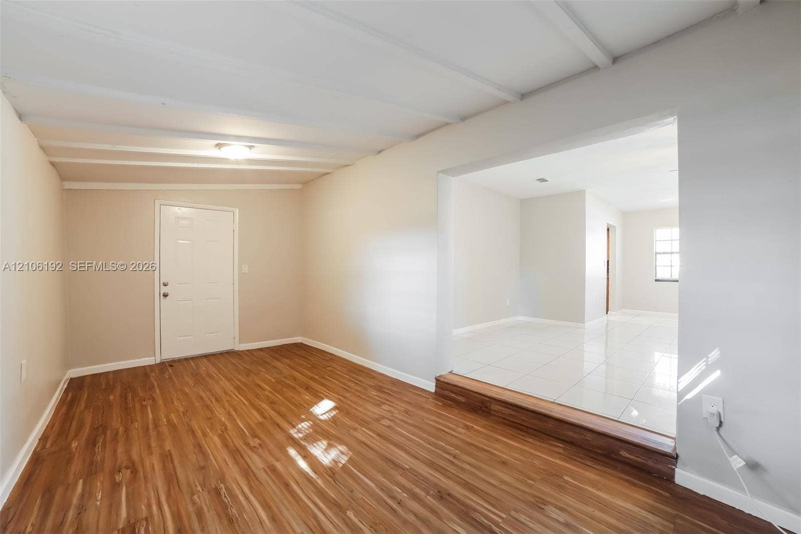 19100 NW 12th Avenue, Miami Gardens, Miami Gardens, FL 33169 Wood-finish flooring, tray ceiling with exposed structural beams, raised threshold, and large-format tile flooring