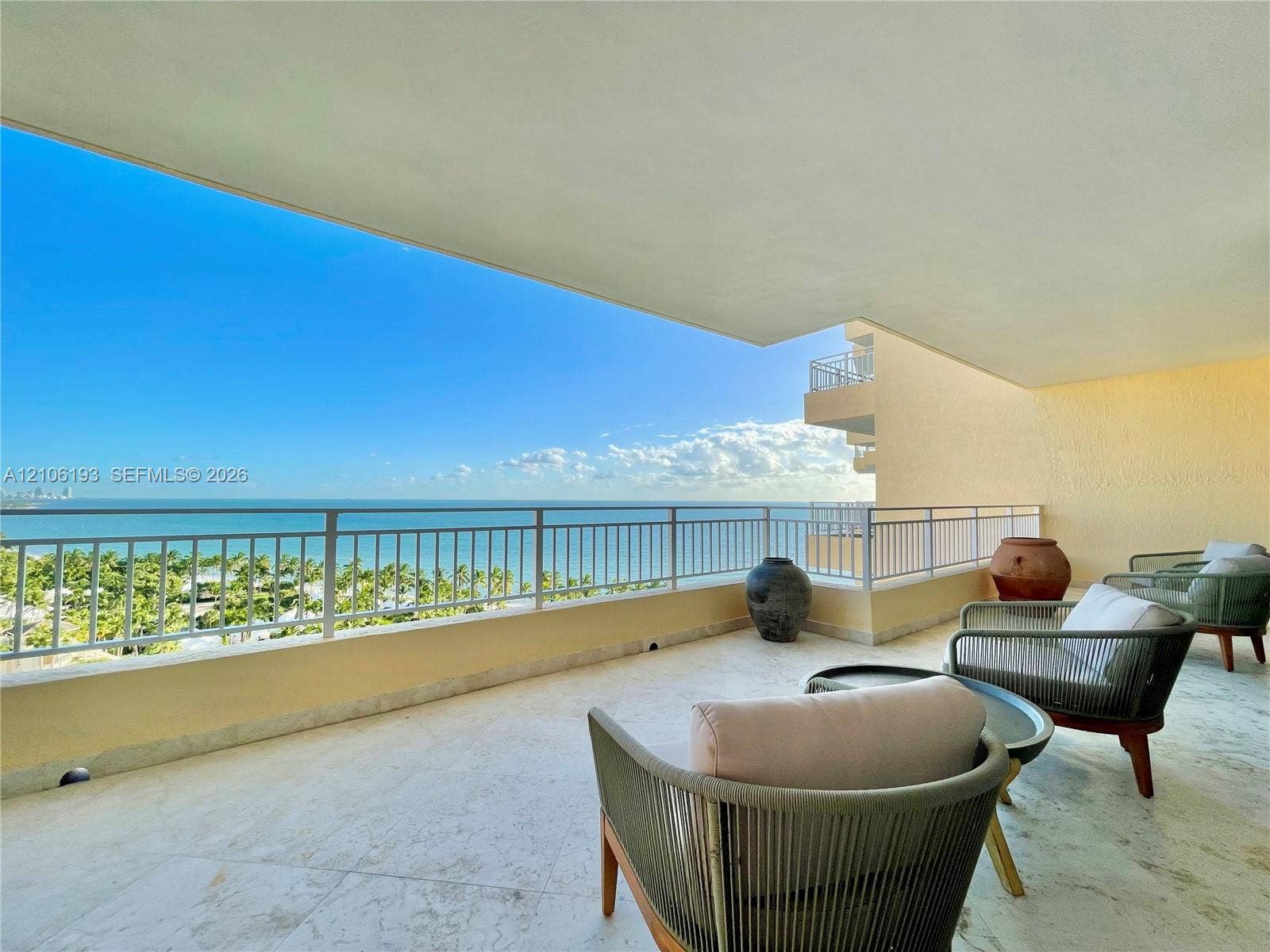 799 Crandon Boulevard, #1203, Key Biscayne, Key Biscayne, FL 33149 Covered balcony featuring stone flooring and a metallic railing overlooking the ocean and coastline