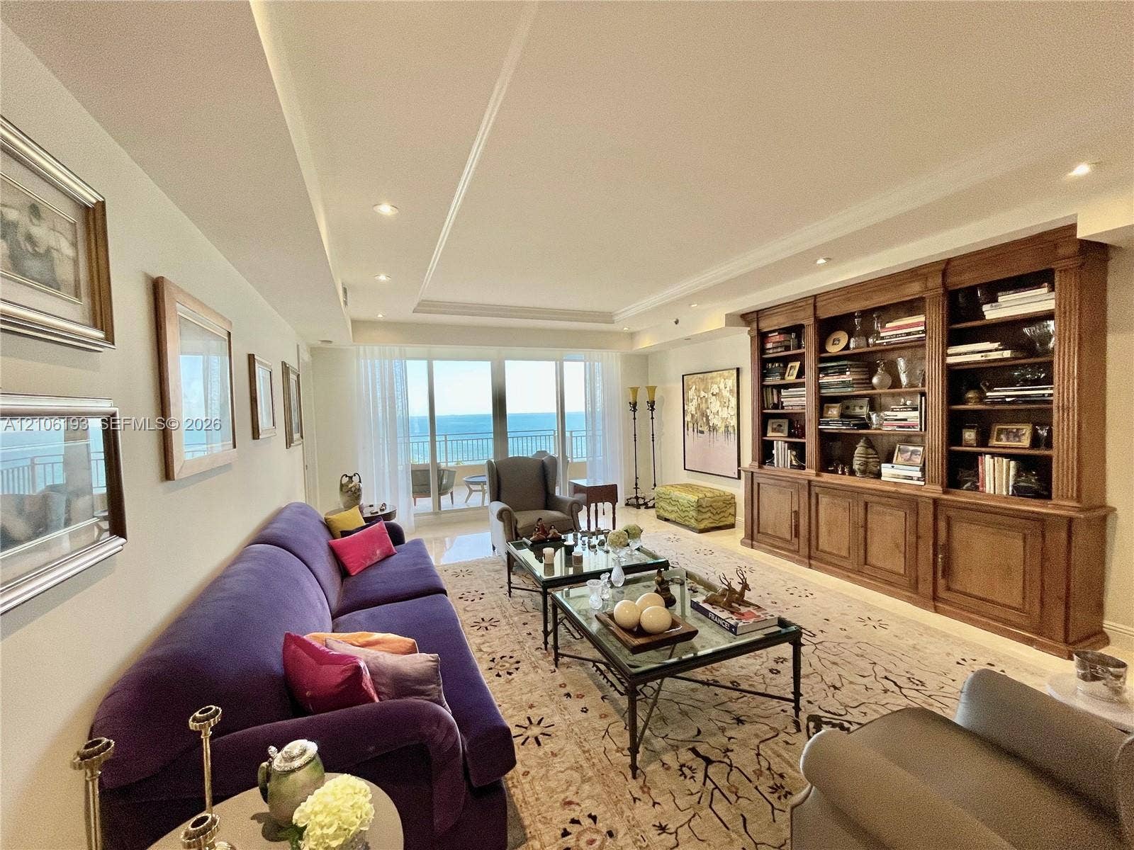 799 Crandon Boulevard, #1203, Key Biscayne, Key Biscayne, FL 33149 Living area featuring floor-to-ceiling glass sliding doors, built-in wooden cabinetry with shelving, recessed ceiling lighting, and tile flooring