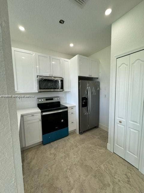 17660 NW 73rd Avenue, #202-3, Hialeah, Hialeah, FL 33015 Kitchen featuring white shaker-style cabinetry, stainless steel appliances, quartz-surface countertops, and ceramic tile flooring