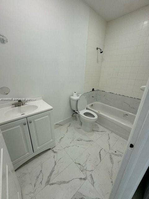 17660 NW 73rd Avenue, #202-3, Hialeah, Hialeah, FL 33015 Bathroom featuring large-format white tile flooring with grey veining, a white vanity with an integrated sink, a porcelain toilet, and a bathtub with tile surround