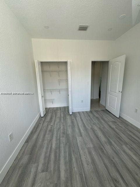 17660 NW 73rd Avenue, #202-3, Hialeah, Hialeah, FL 33015 Room featuring wood-finish flooring, recessed lighting, and a closet with built-in wire shelving