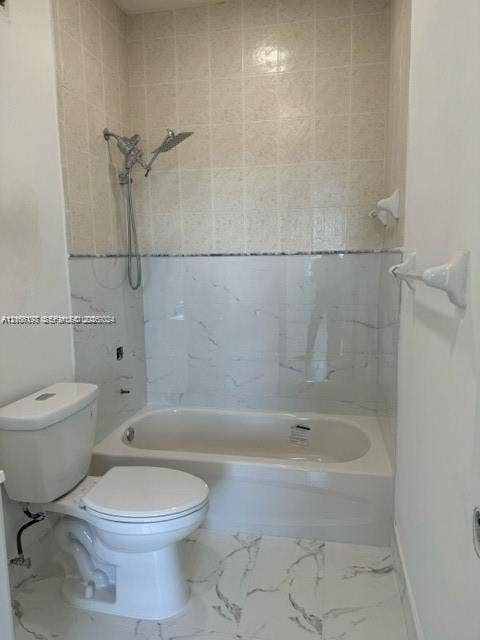 17660 NW 73rd Avenue, #202-3, Hialeah, Hialeah, FL 33015 Bathtub featuring stone-pattern wall tile, hand-held shower fixture, and stone-pattern floor tile