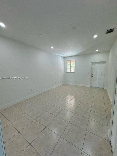 17660 NW 73rd Avenue, #202-3, Hialeah, Hialeah, FL 33015 Neutral-toned tile flooring, recessed ceiling lighting, and a multi-panel entry door
