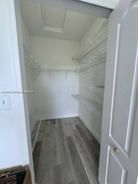 17660 NW 73rd Avenue, #202-3, Hialeah, Hialeah, FL 33015 Walk-in closet featuring wood-finish flooring and multi-level white wire shelving