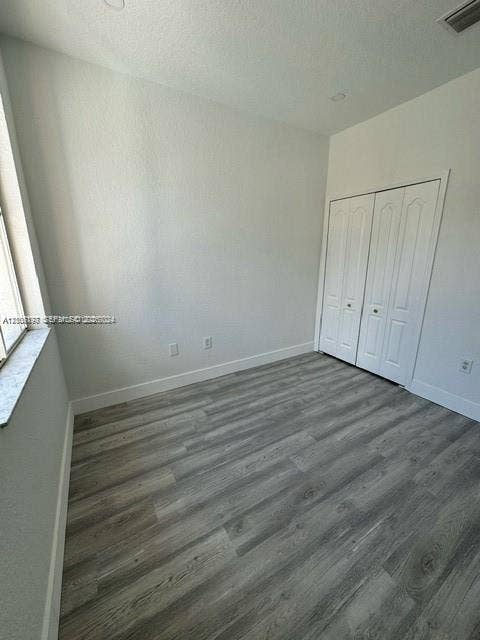 17660 NW 73rd Avenue, #202-3, Hialeah, Hialeah, FL 33015 Interior space featuring neutral wall paint, wood-finish flooring, recessed lighting, and a double-door closet