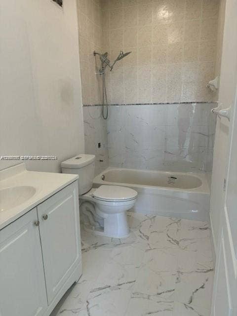 17660 NW 73rd Avenue, #202-3, Hialeah, Hialeah, FL 33015 Bathroom featuring white vanity with integrated sink, porcelain tile flooring with veined detailing, tub-shower combination with tiled surround, and chrome adjustable-head shower fixture
