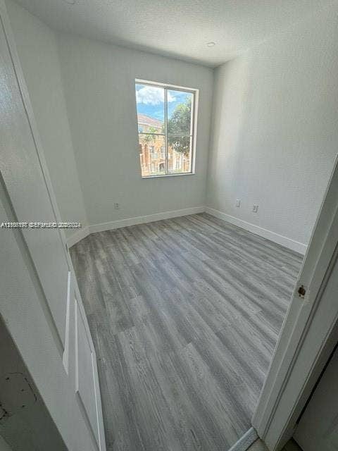 17660 NW 73rd Avenue, #202-3, Hialeah, Hialeah, FL 33015 Room featuring neutral-toned walls, wood-finish flooring, and a single-pane window