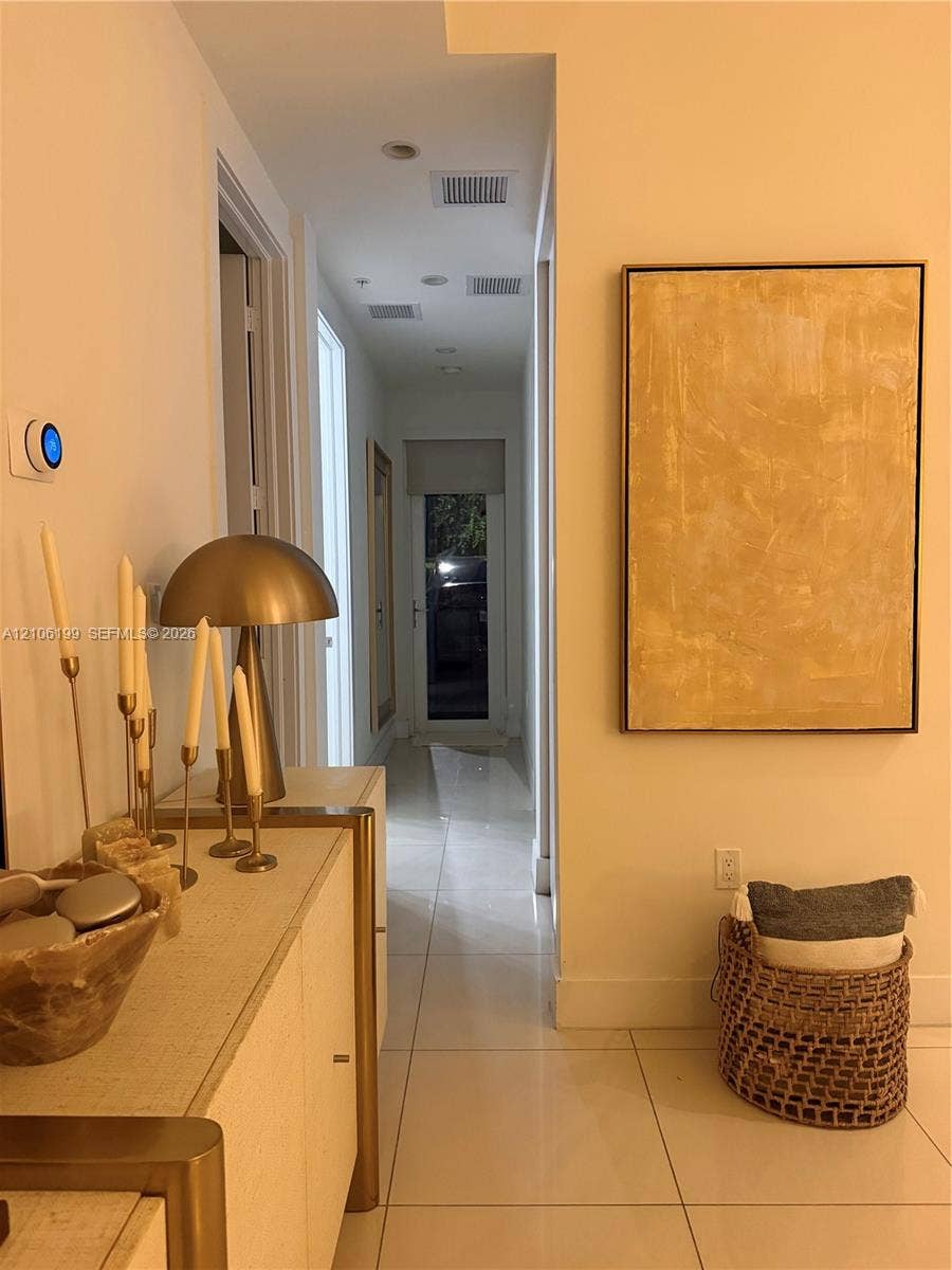 Hallway featuring large-format tile flooring and recessed ceiling lighting