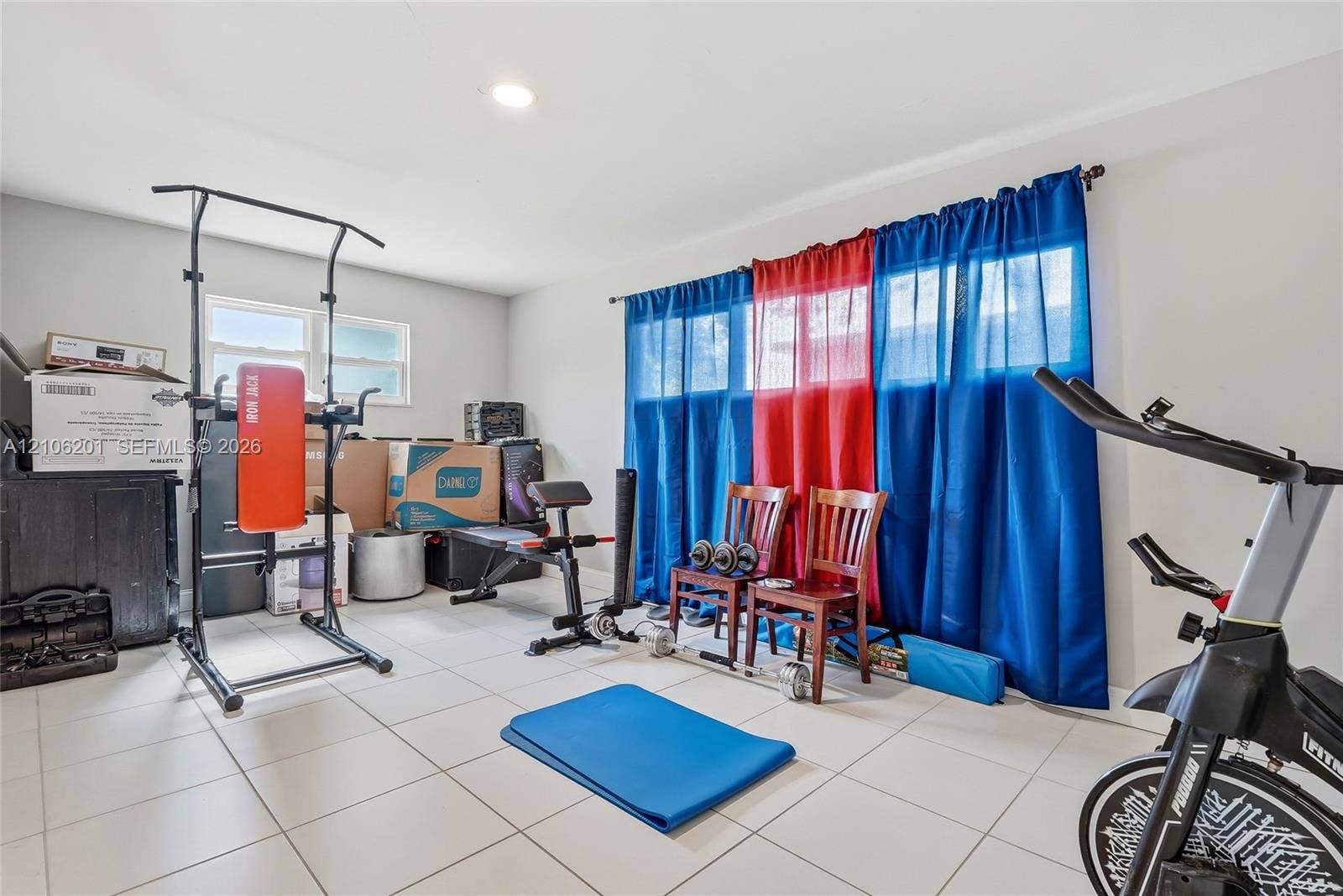 Room featuring ceramic tile flooring, neutral wall paint, and recessed lighting, with windows providing natural light