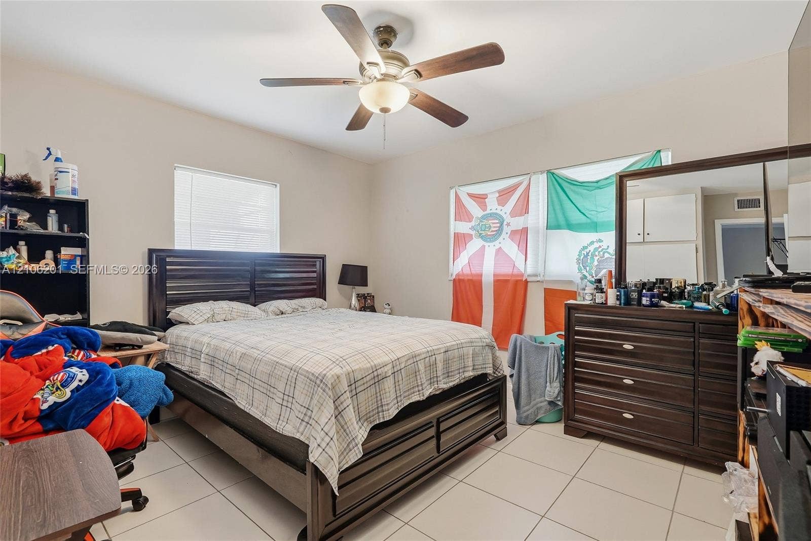 Neutral-toned room featuring large-format tile flooring and a ceiling fan with integrated lighting