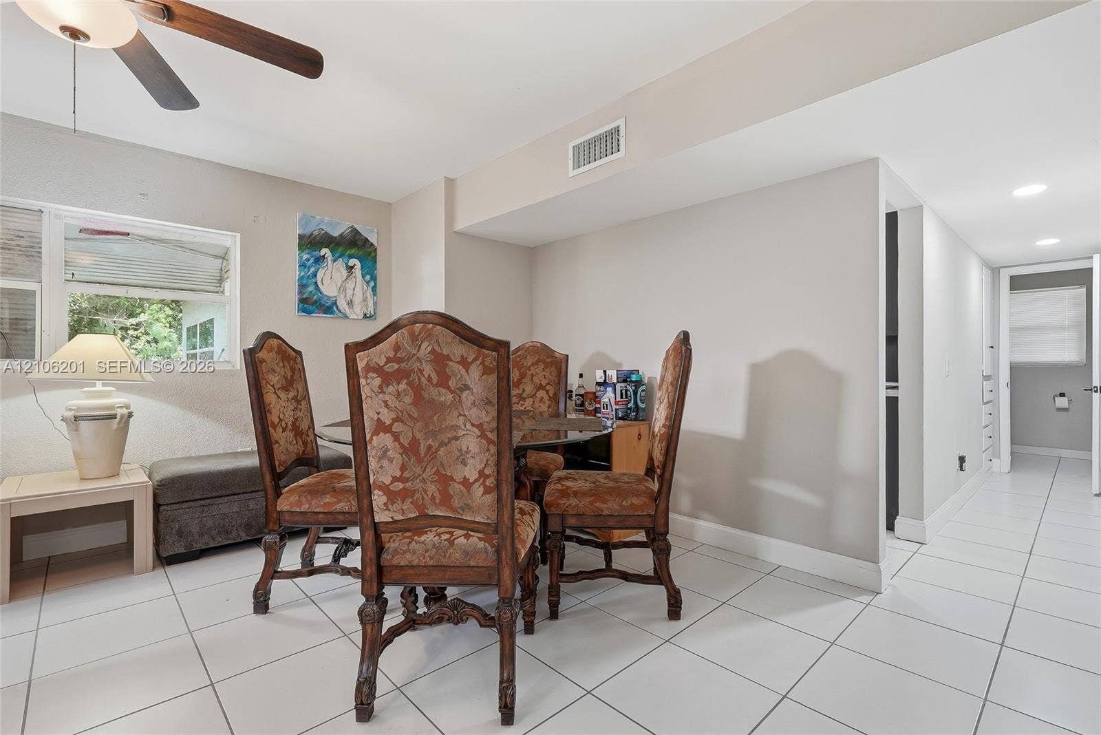Neutral-toned interior featuring ceramic tile flooring, a dual-tone ceiling fan with integrated lighting, and recessed overhead illumination