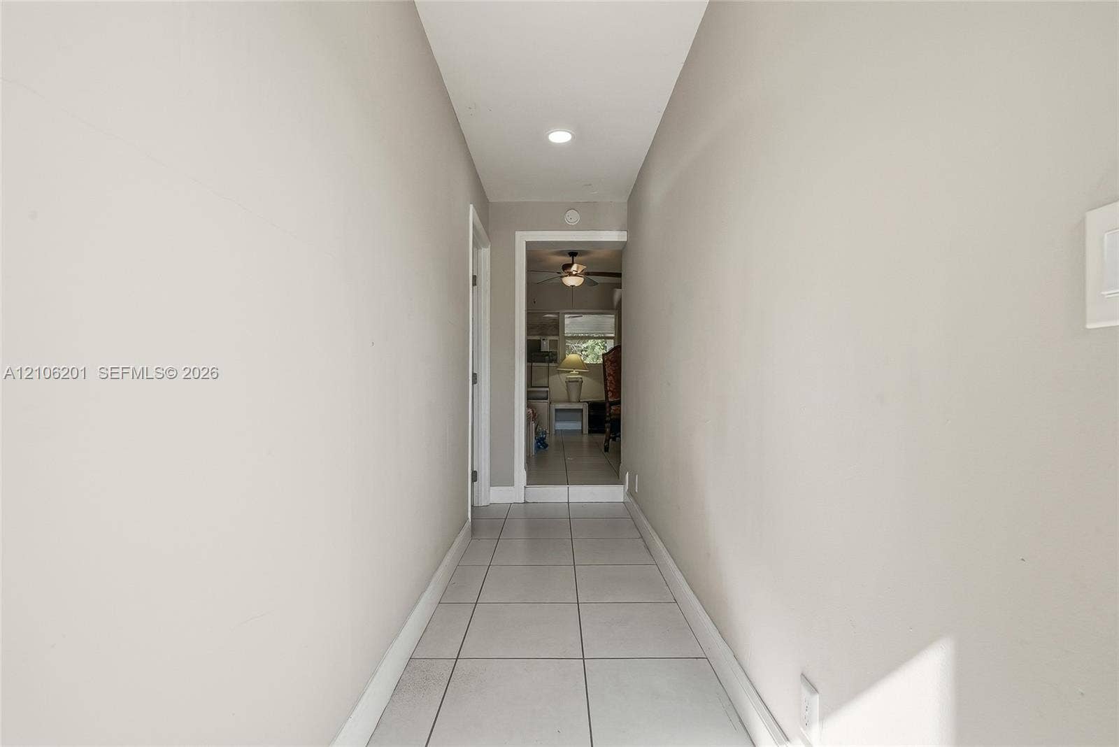 Hallway featuring ceramic tile flooring, recessed ceiling lighting, and neutral wall paint