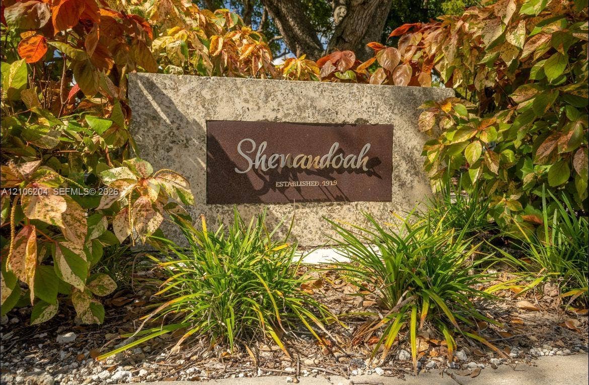 2121 SW 13th Avenue, #Studio, Miami, Miami, FL 33145 Stone monument signage featuring an inset metal plaque with etched lettering and lush surrounding landscaping