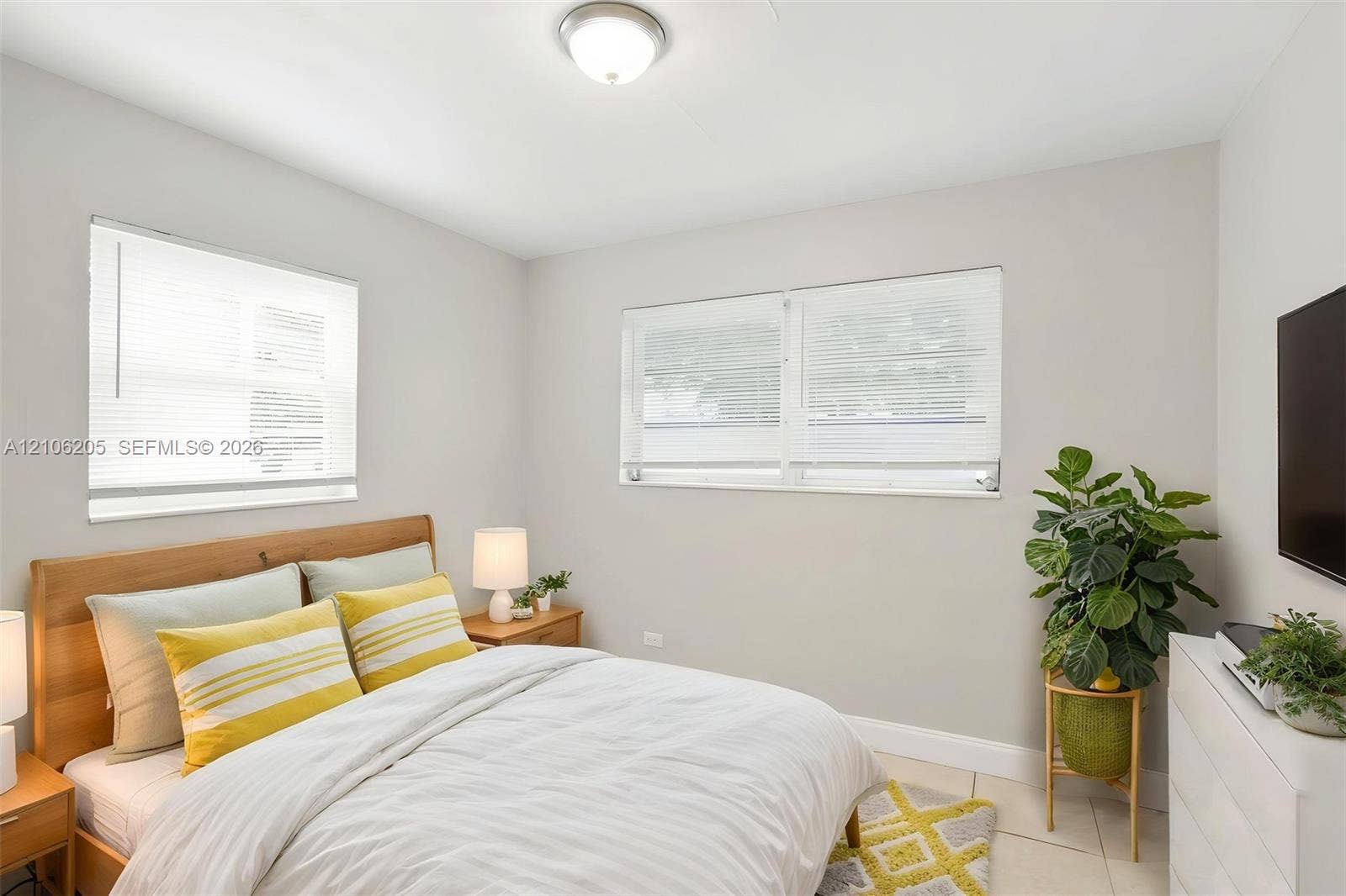 6941 SW 5th Street, Pembroke Pines, Pembroke Pines, FL 33023 Neutral wall paint, two dual-pane windows with integrated blinds, tile flooring, and a flush-mount overhead light fixture