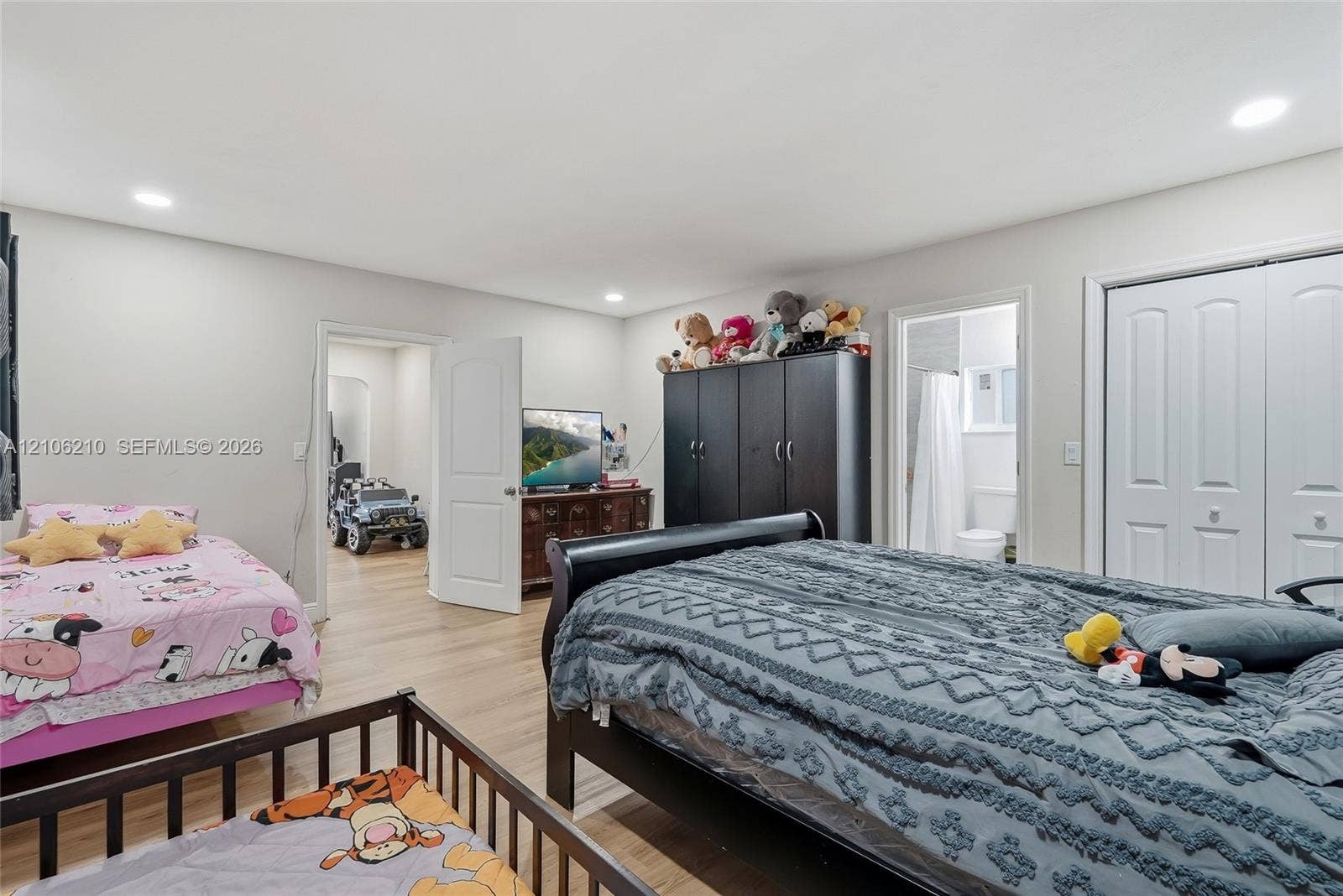 1111 S 7th Street, Fort Pierce, FL 34950 Room featuring wood-finish flooring, recessed lighting, and double-panel doors leading to a closet