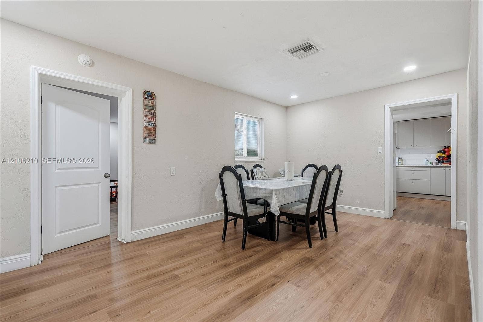 1111 S 7th Street, Fort Pierce, FL 34950 Dining area featuring wood-finish flooring, recessed lighting, and a single-pane window