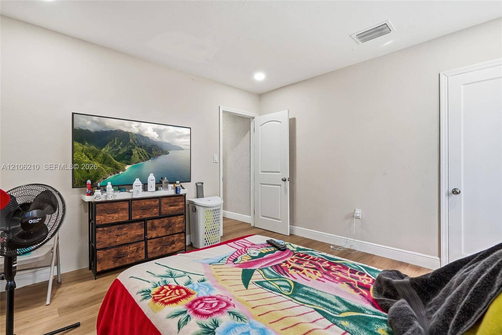 1111 S 7th Street, Fort Pierce, FL 34950 Neutral interior room featuring wood-finish flooring, recessed lighting, and white arched-panel doors