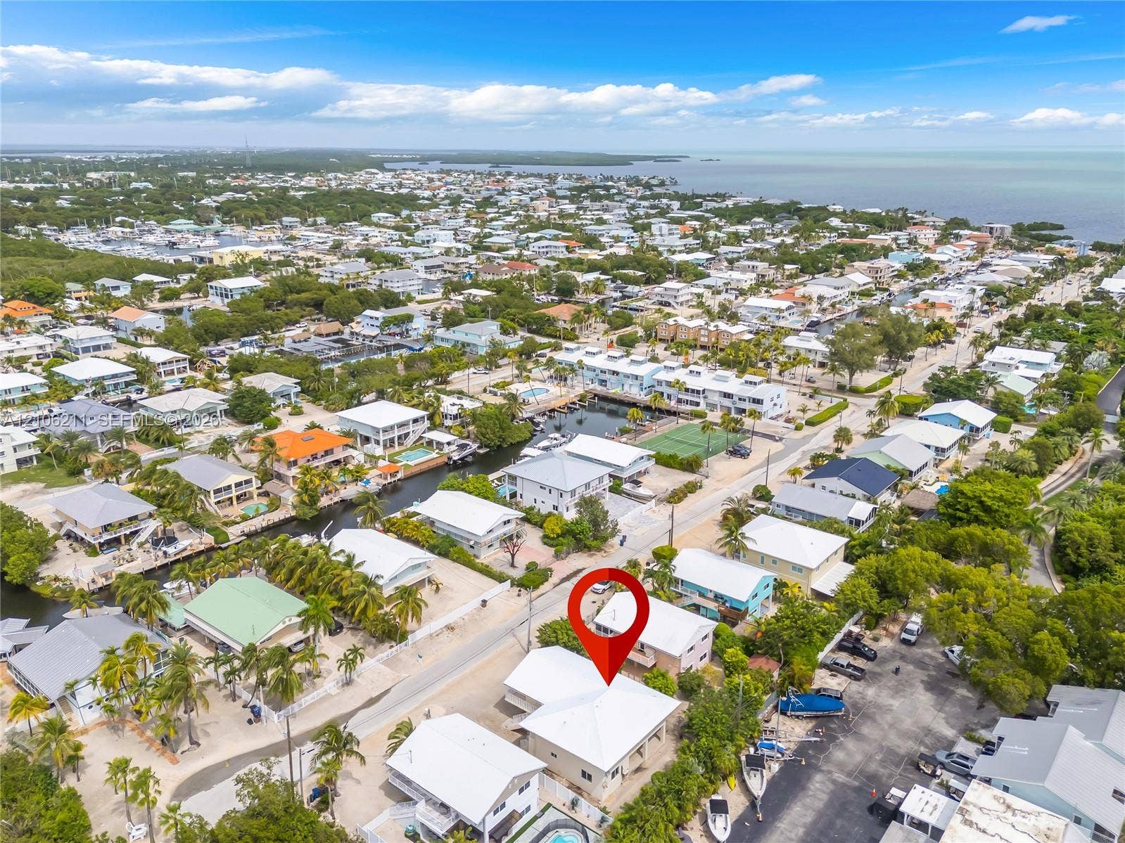 Aerial perspective featuring proximity to coastal waterways and mature tropical foliage