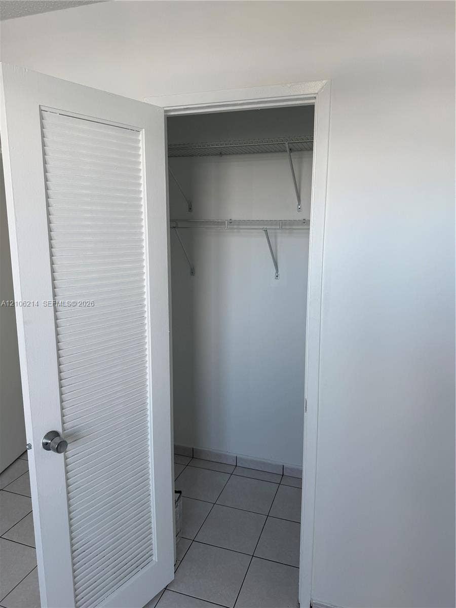 2841 NE 163rd Street, #305, North Miami Beach, North Miami Beach, FL 33160 Closet featuring louvered door, white wall finish, and wire shelving