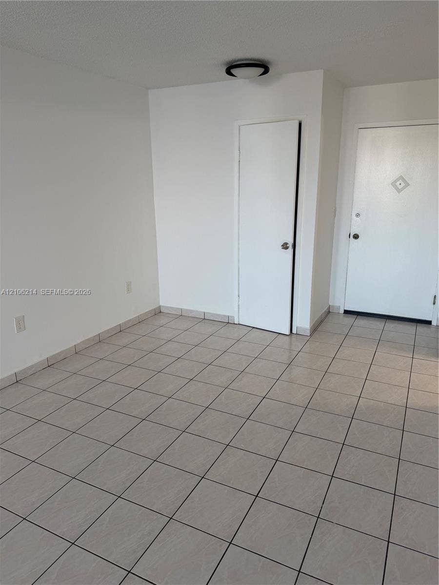 2841 NE 163rd Street, #305, North Miami Beach, North Miami Beach, FL 33160 Neutral-toned ceramic tile flooring, solid-core interior doors, and low-profile flush-mount ceiling lighting
