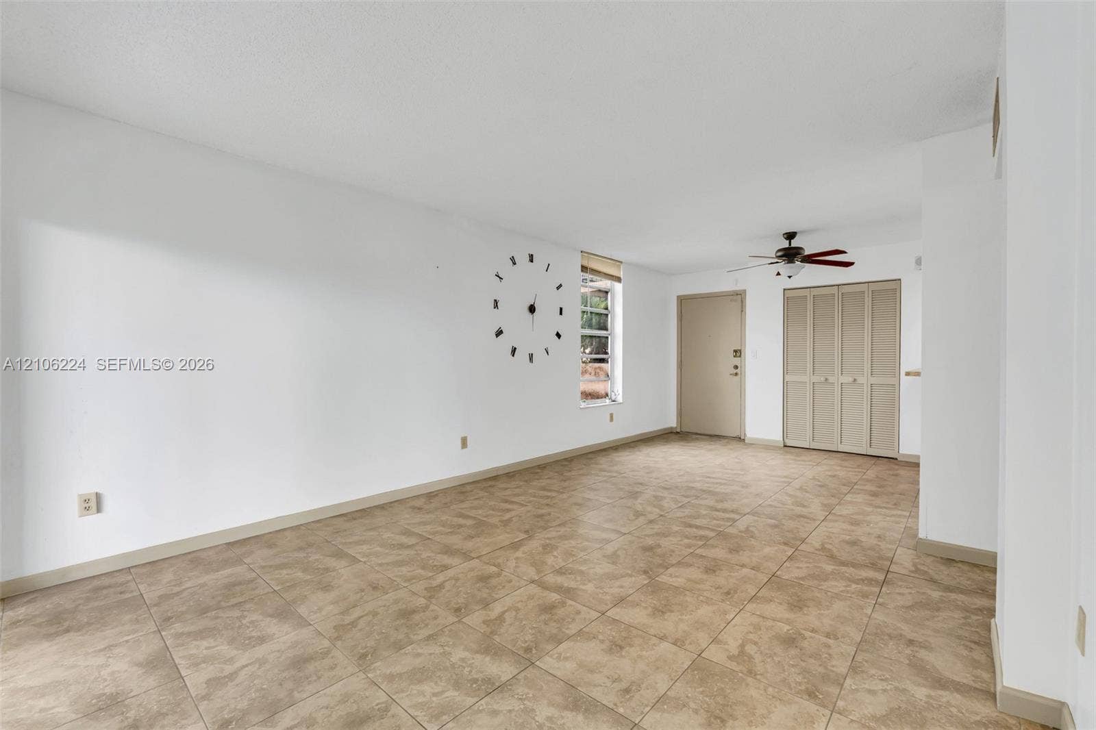 8887 Fontainebleau Boulevard, #206, Miami, Miami, FL 33172 Neutral-toned tile flooring, ceiling fan with light fixture, and bi-fold closet doors