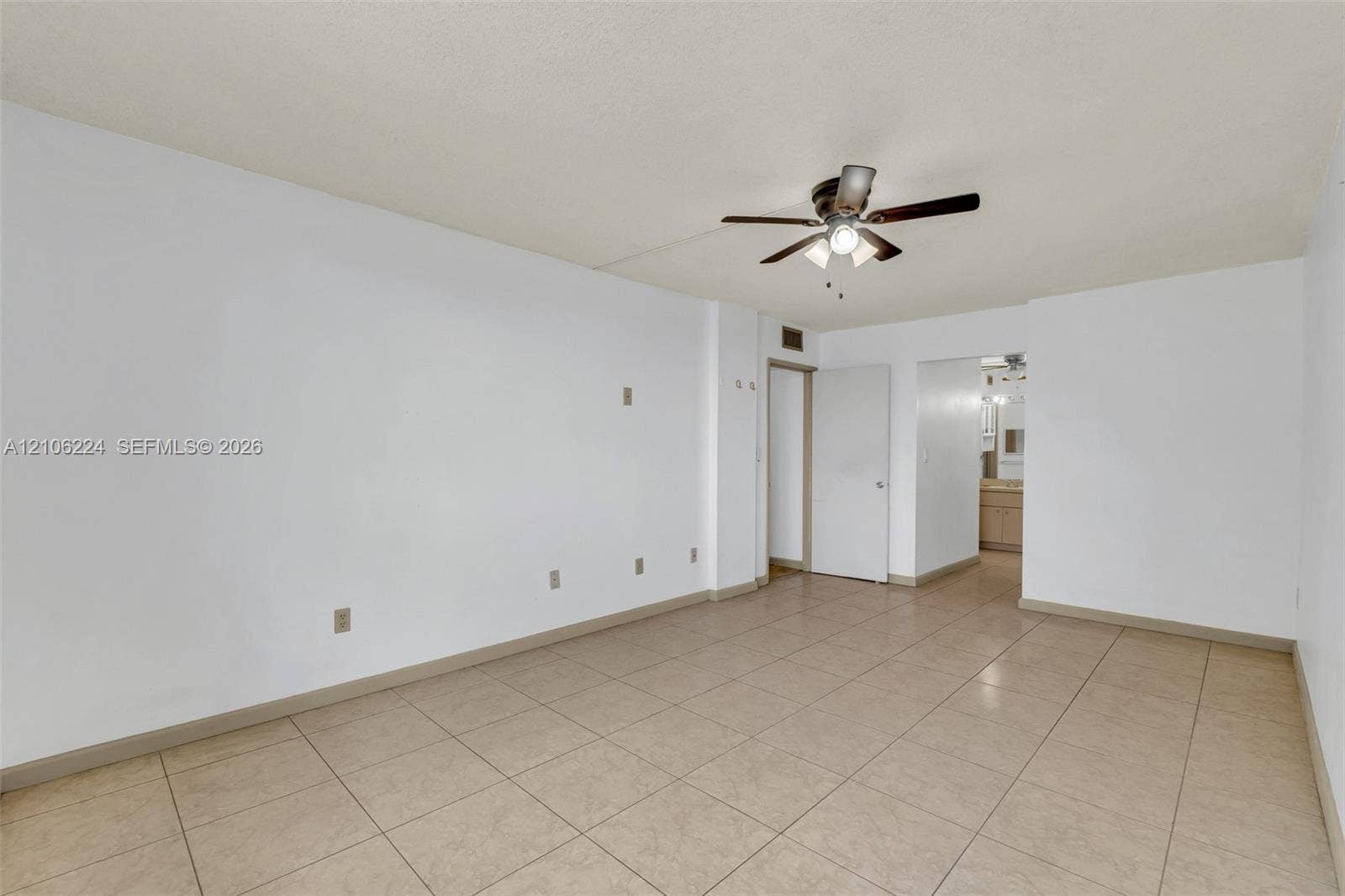 8887 Fontainebleau Boulevard, #206, Miami, Miami, FL 33172 Interior space featuring neutral-toned tile flooring, white walls, and a ceiling-mounted light fixture with a multi-blade fan
