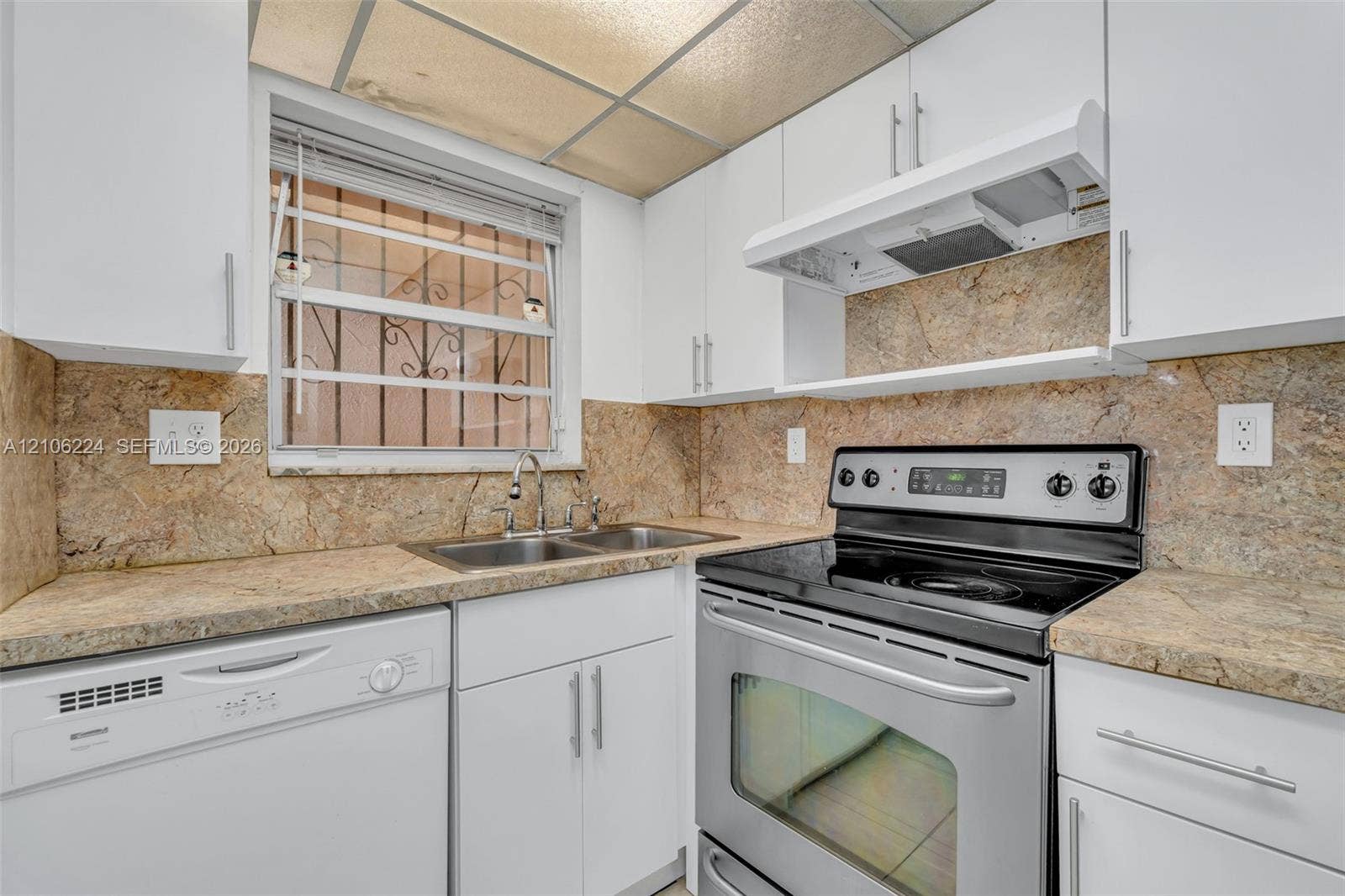 8887 Fontainebleau Boulevard, #206, Miami, Miami, FL 33172 Kitchen featuring white cabinetry, stone-finish countertops, full-height stone-finish backsplash, stainless steel range, and integrated dishwasher