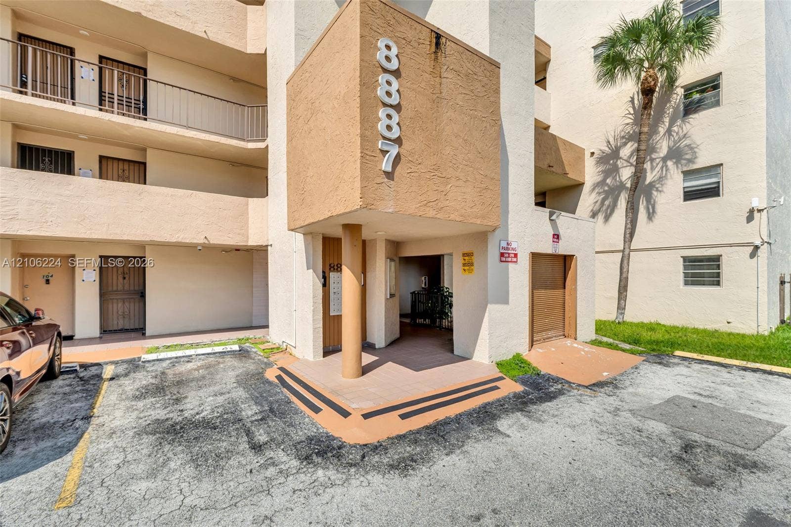 8887 Fontainebleau Boulevard, #206, Miami, Miami, FL 33172 Multi-story stucco exterior featuring private balconies with metal railings, a covered entrance, and built-in wall-mounted numbering