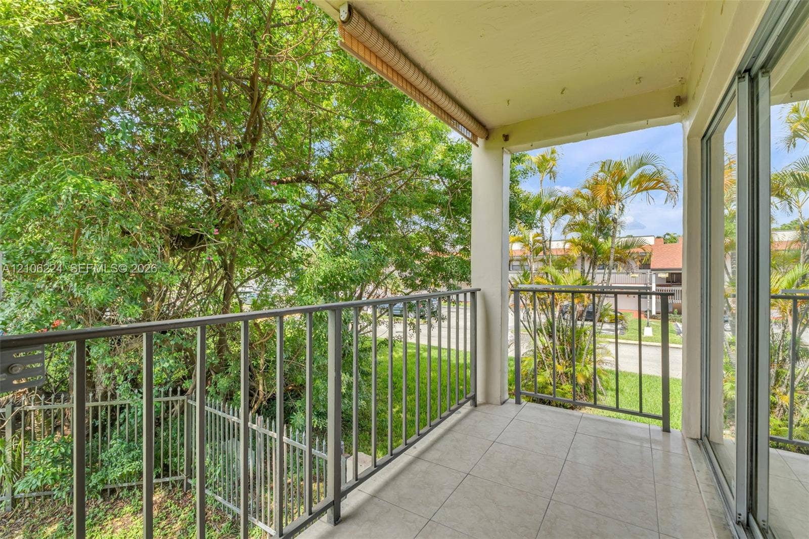 8887 Fontainebleau Boulevard, #206, Miami, Miami, FL 33172 Covered balcony featuring tile flooring, metal railings, and a retractable fabric awning