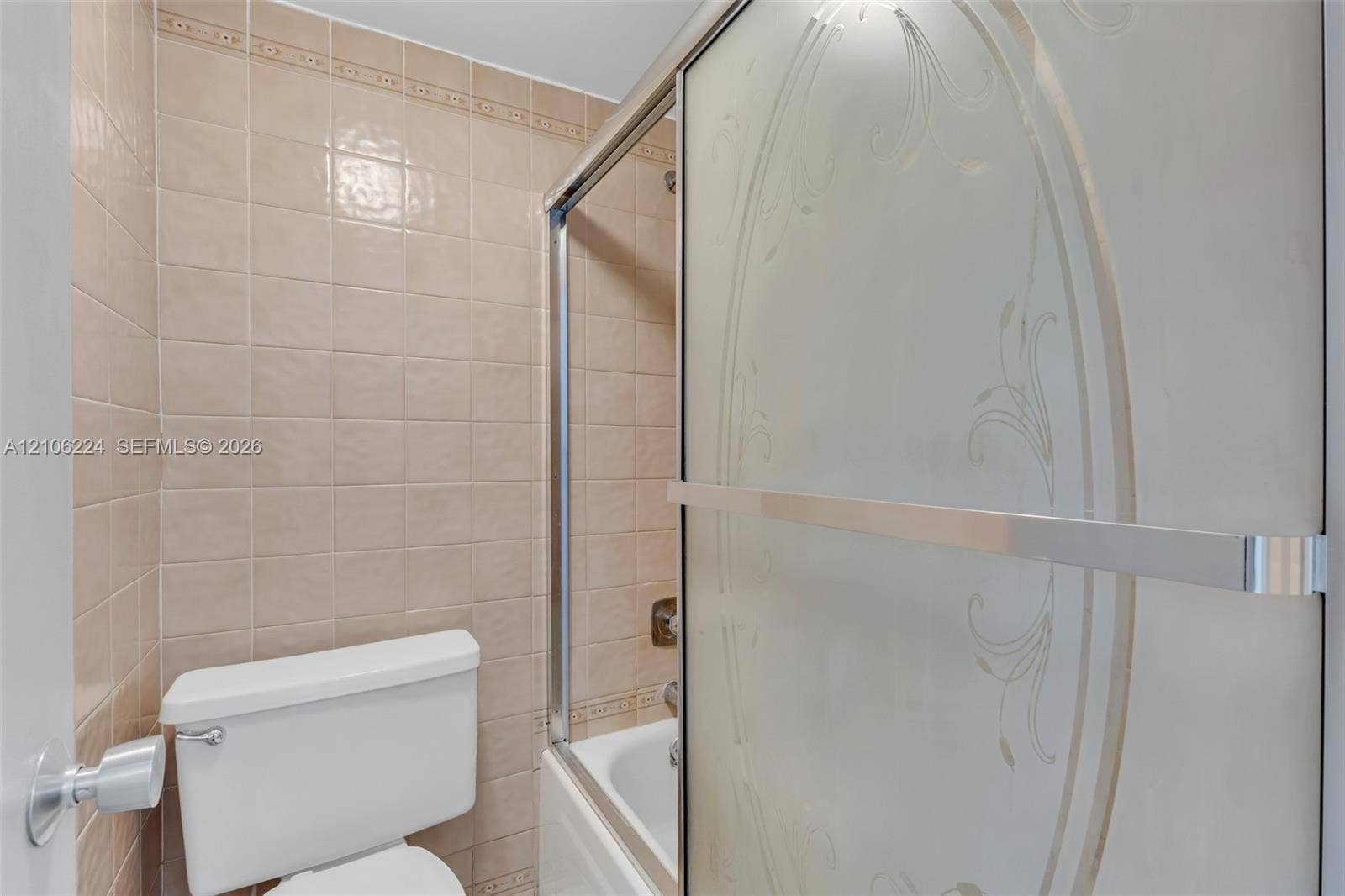 8887 Fontainebleau Boulevard, #206, Miami, Miami, FL 33172 Full-height square wall tile, sliding shower door with decorative etched detailing, and integrated bathtub