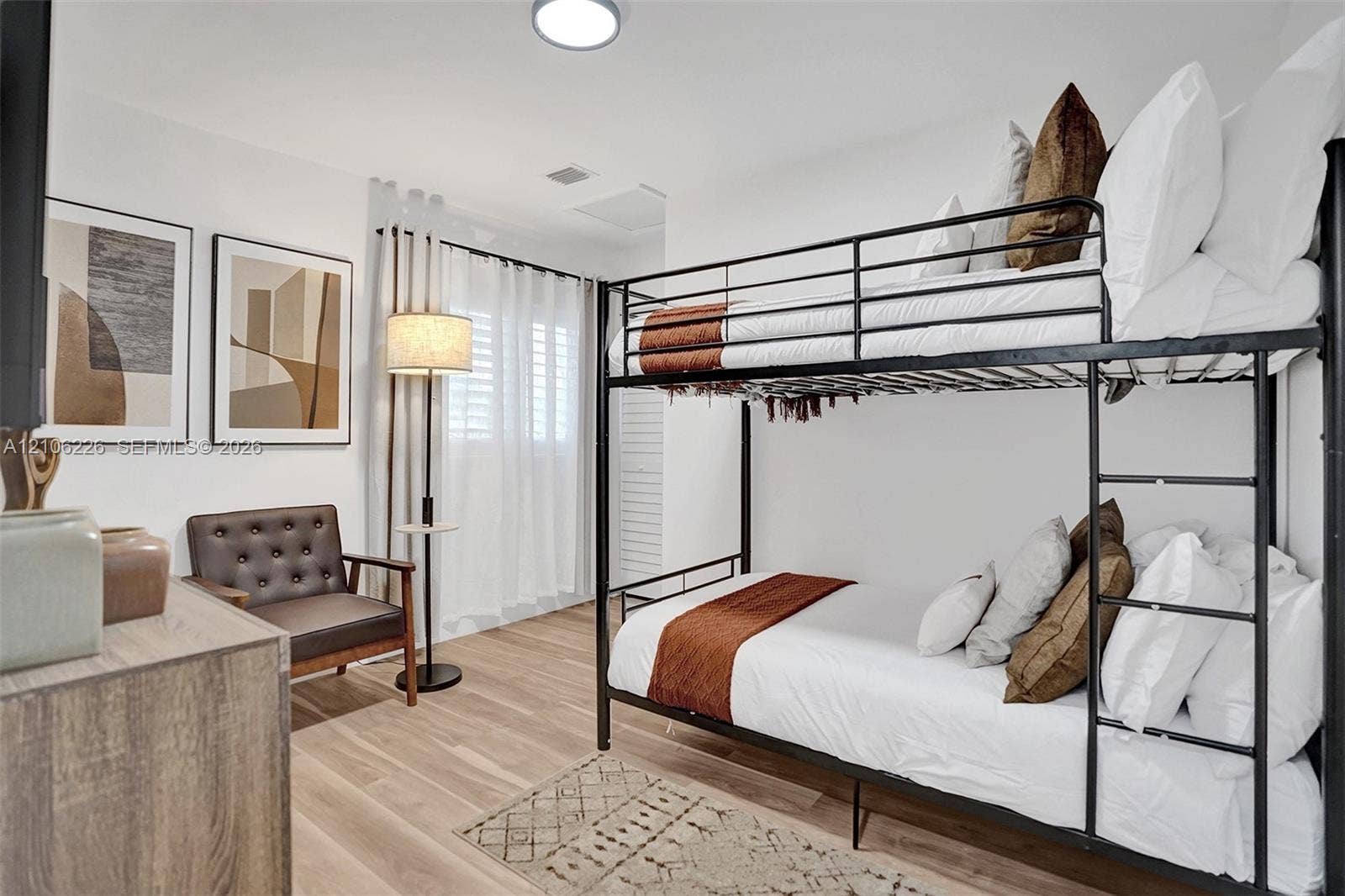 11155 SW 40th Street, Davie, FL 33328 Neutral-toned wood-finish flooring, white walls, and interior window shutters
