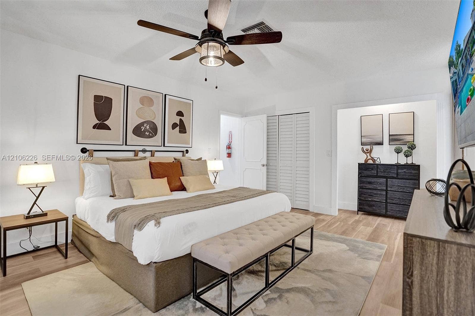 11155 SW 40th Street, Davie, FL 33328 Wood-finish flooring, ceiling fan with integrated lighting, and louvered closet doors