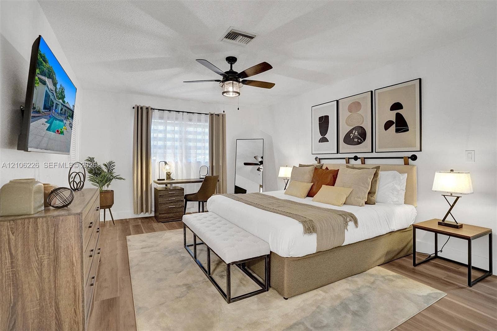 11155 SW 40th Street, Davie, FL 33328 Wood-finish flooring, neutral walls, and a ceiling fan with integrated lighting
