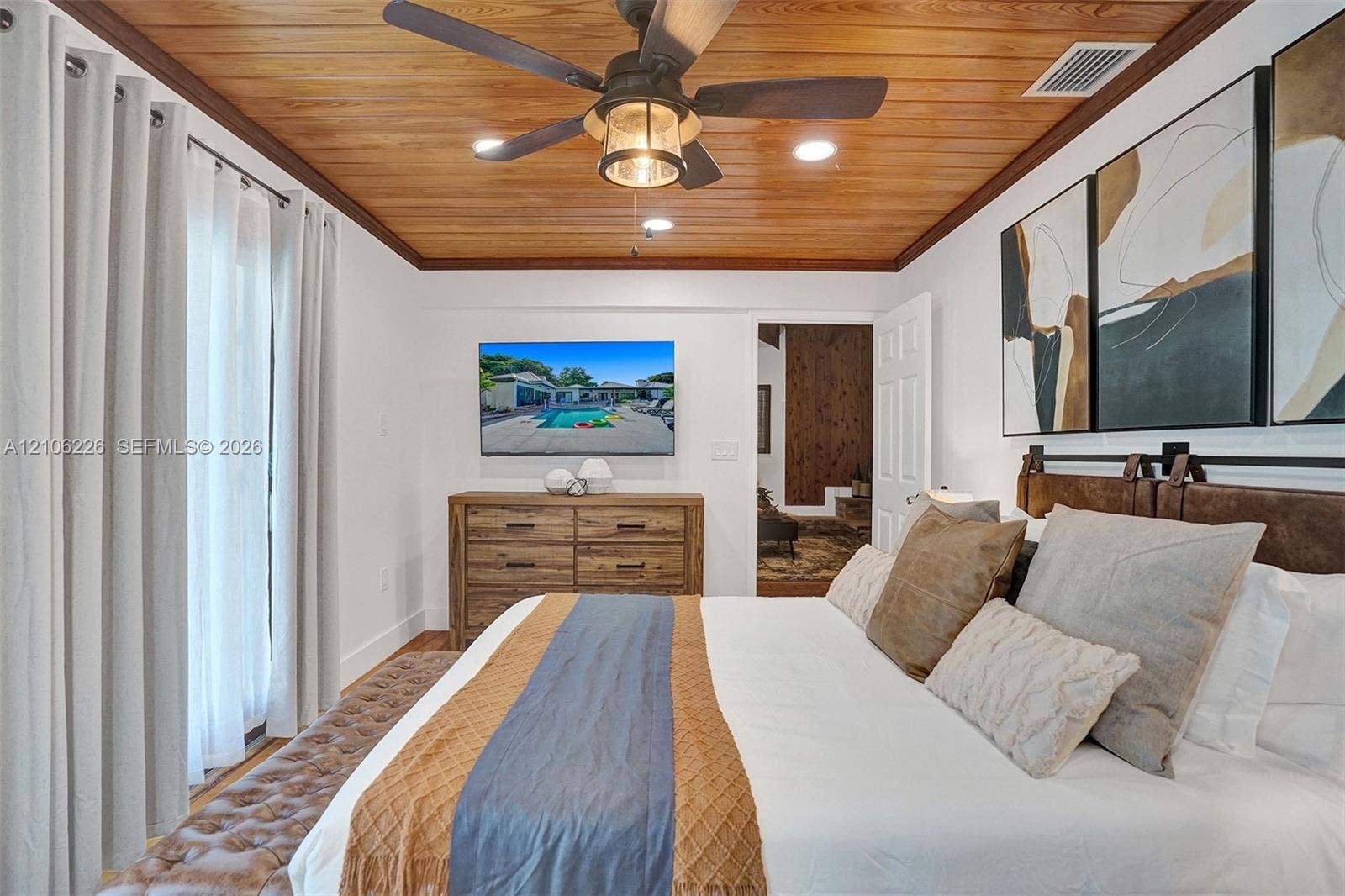 11155 SW 40th Street, Davie, FL 33328 Wood-plank ceiling with crown molding, ceiling fan with integrated light fixture, and recessed lighting