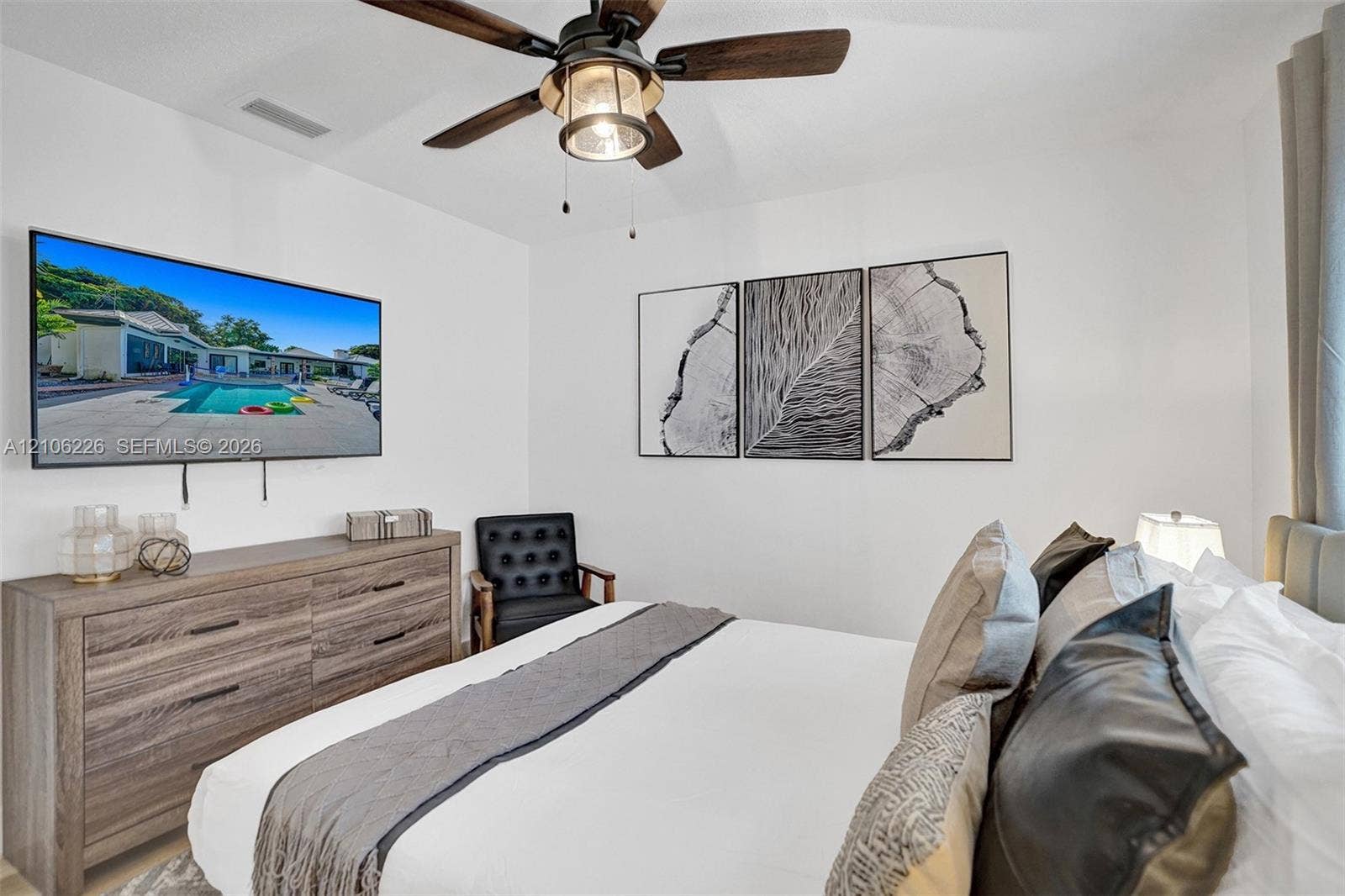 11155 SW 40th Street, Davie, FL 33328 Bedroom featuring a high-contrast ceiling fan with integrated lighting