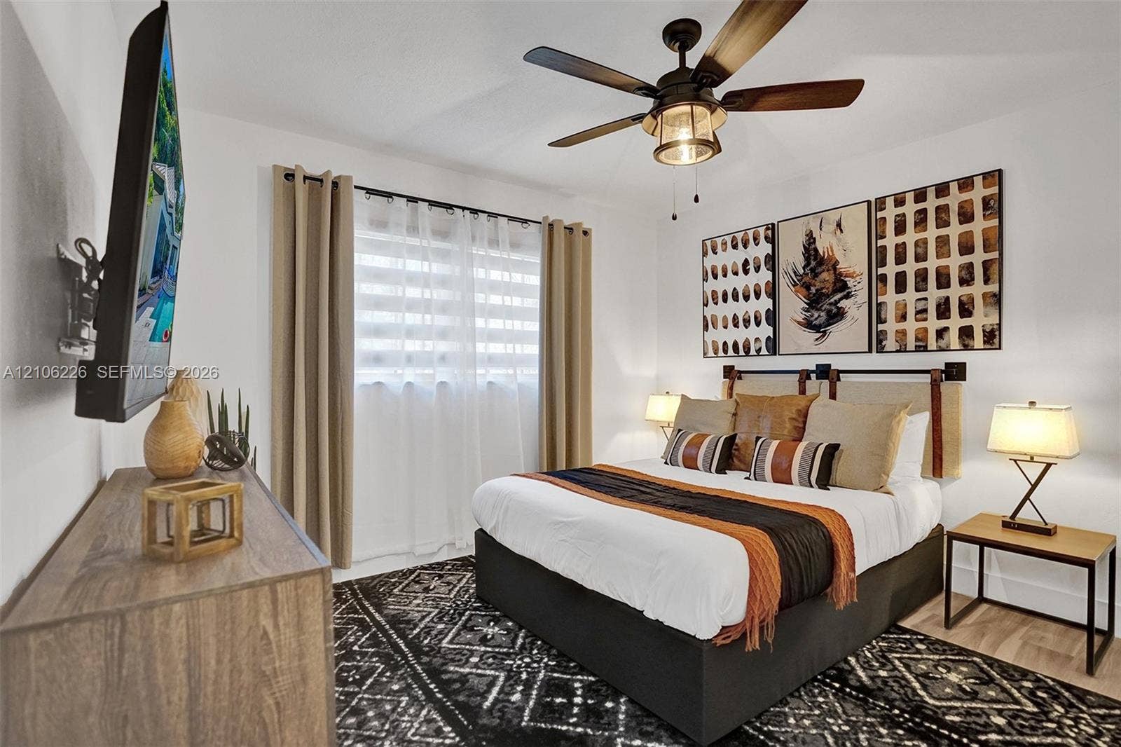 11155 SW 40th Street, Davie, FL 33328 Bedroom featuring a ceiling fan with integrated lighting and wood-finish flooring