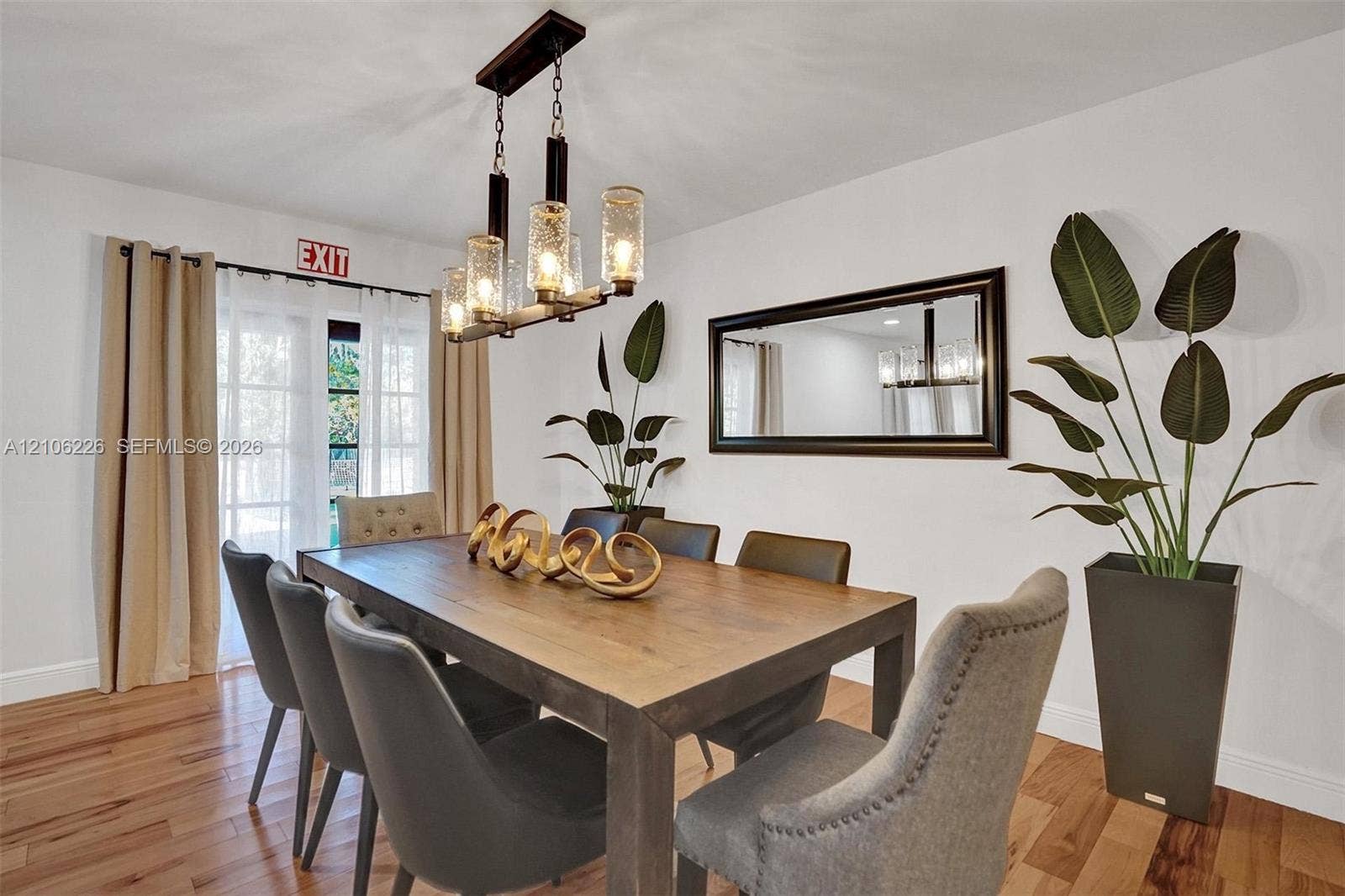 11155 SW 40th Street, Davie, FL 33328 Hardwood flooring, multi-light linear chandelier with seeded glass shades, and double French doors