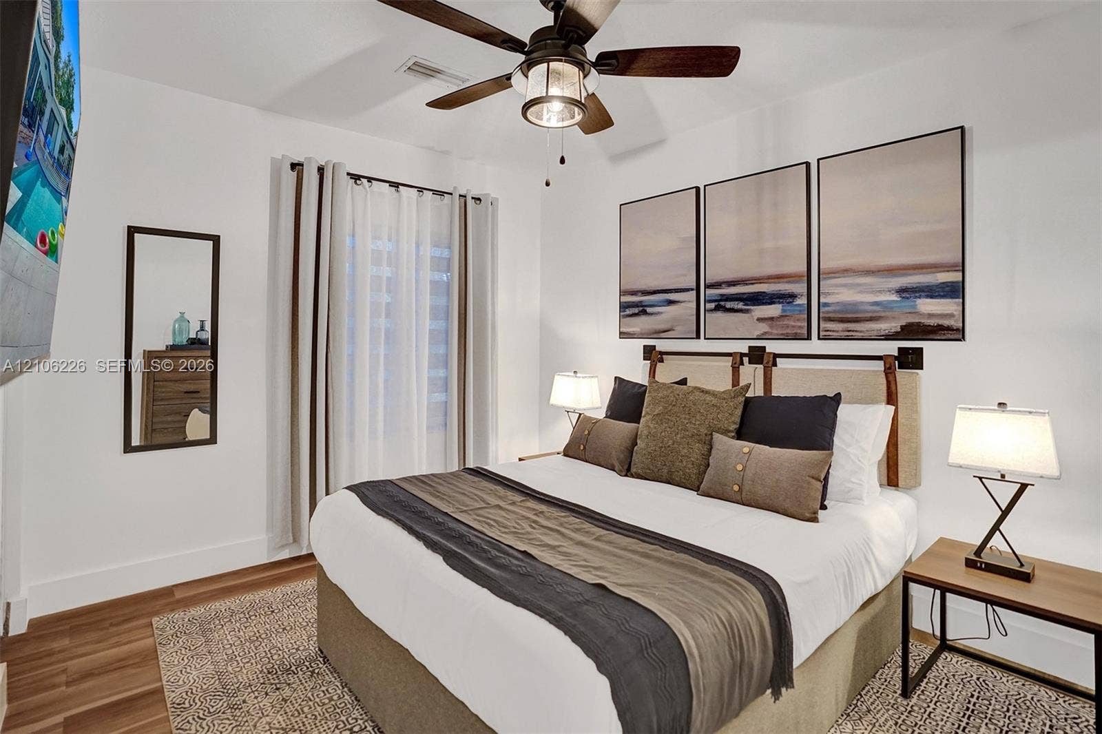 11155 SW 40th Street, Davie, FL 33328 Wood-finish flooring, neutral walls, and a ceiling fan with integrated lighting