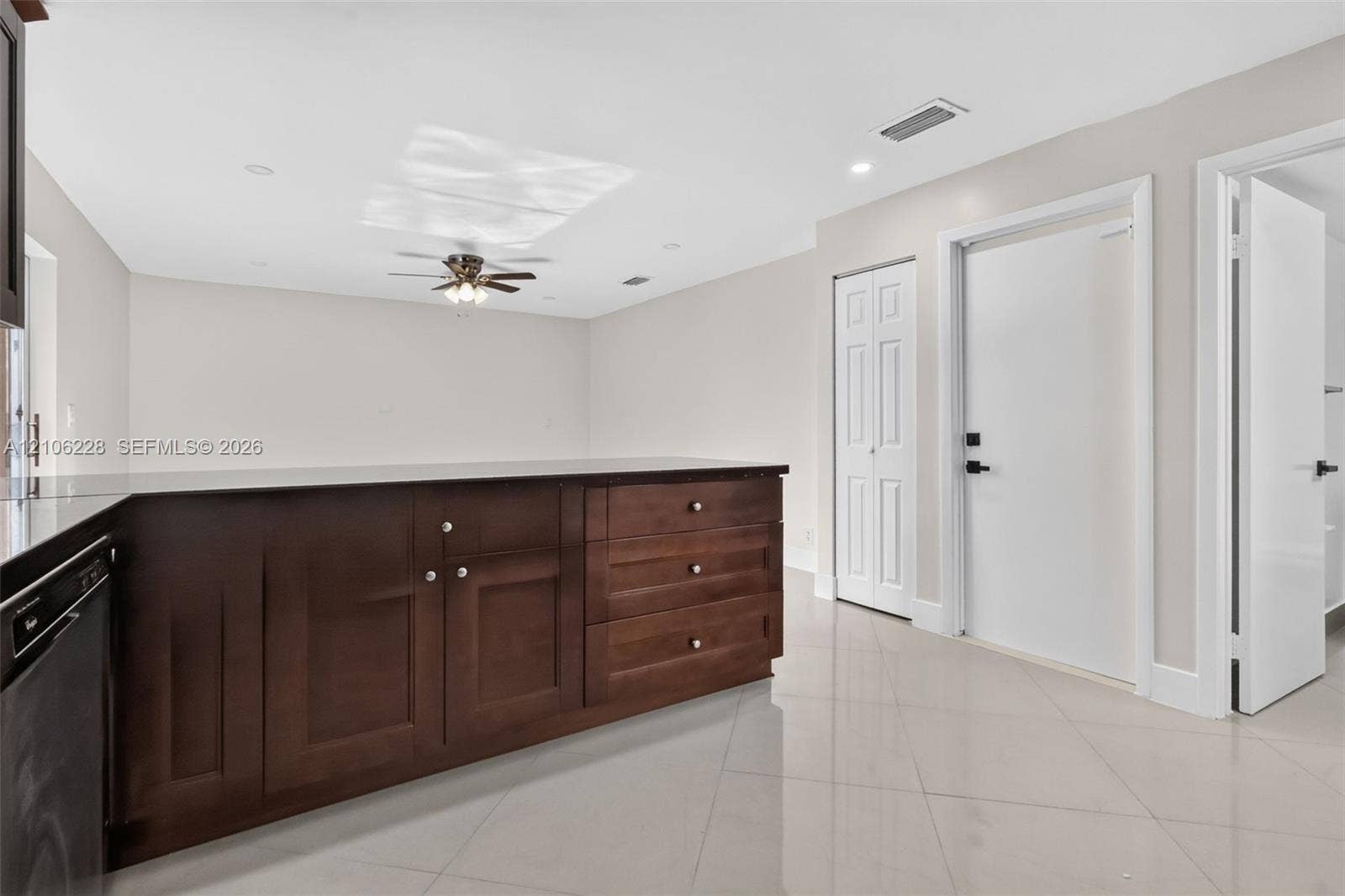 10760 SW 11th Drive, Davie, FL 33324 Kitchen featuring dark wood-finish cabinetry, a dark countertop, recessed lighting, a ceiling fan, and tile flooring